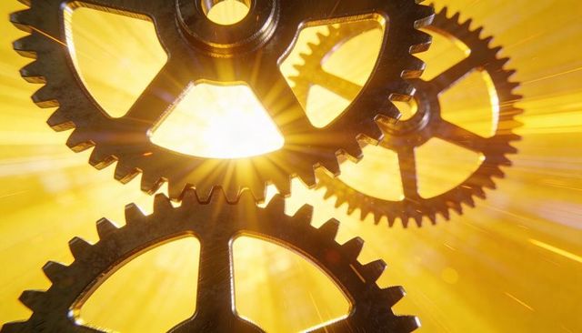 Golden sunburst gears rotating with sparks, interlocking metal cogs in dynamic motion