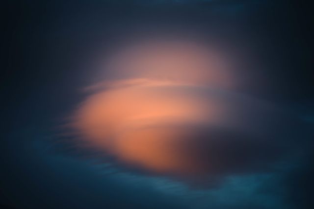 Abstract glowing cloud blending into dark sky with gradient effect. Suitable for backgrounds, desktop wallpapers, and calming illustrations. Use for projects relating to serenity, tranquility, or natural beauty.