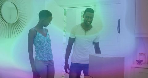 Couple Assessing Moving Boxes Sundrenched Entryway Daylight