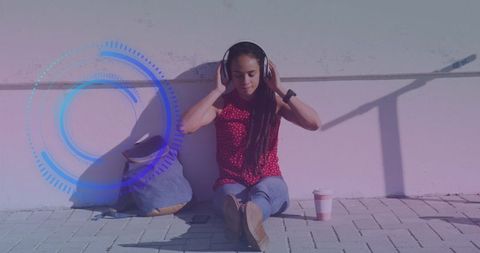 Young Woman Listening to Music with Digital Interface