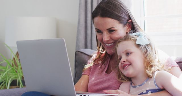 Smiling Mother and Daughter Using Laptop at Home - Download Free Stock Images Pikwizard.com