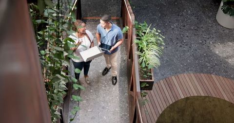 Colleagues Discussing Project in Sustainable Office Environment