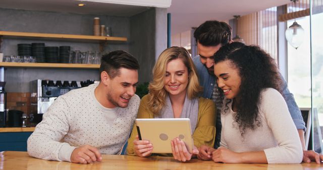 Group of Friends Watching Tablet in Cozy Cafe - Download Free Stock Images Pikwizard.com