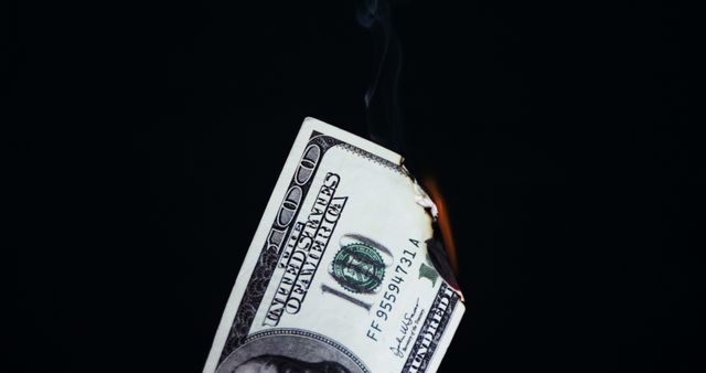 Close-up of euro dollar burning against black background