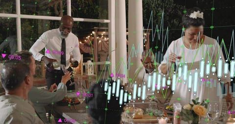 Evening outdoor dinner party toasting guests on veranda with wine, candles and data graphs