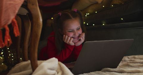 Girl Enjoying Laptop Under Cosy DIY Blanket Fort