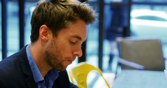 Young Professional Man Sitting in Modern Office Environment - Download Free Stock Images Pikwizard.com