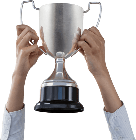 Hands raising transparent silver trophy in celebration