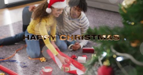 Couple wrapping christmas gifts by tree with santa hat in cozy living room scene