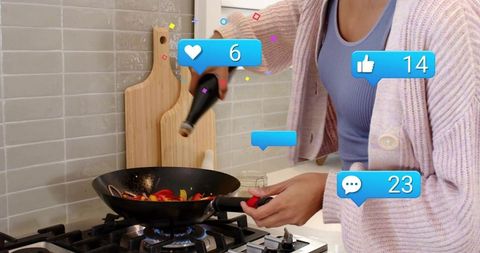 Home cook pouring oil into wok while creating social media cooking content with engagement icons