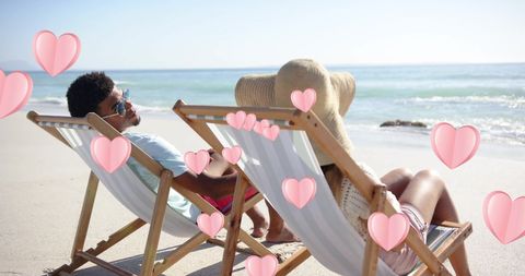 Couple Relaxing in Deckchairs on a Romantic Beach Getaway