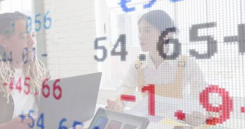 Business professionals analyzing market data in office workspace