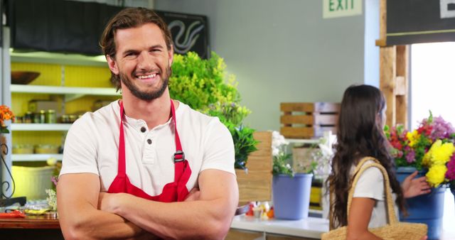 Smiling Florist in Flower Shop Wearing Apron with Female Customer in Background - Download Free Stock Images Pikwizard.com