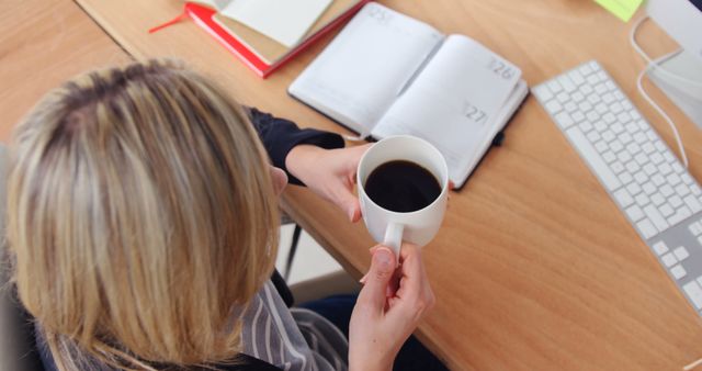 Woman Holding Coffee Cup While Planning in Office - Download Free Stock Images Pikwizard.com