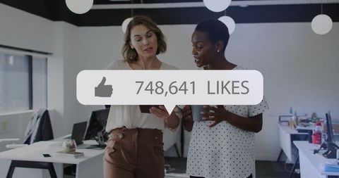 Professional Coworkers Discussing Social Media Success in Modern Office