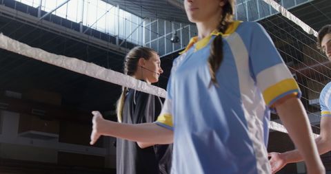 Young Woman Ready to Serve in Intense Volleyball Match