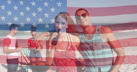 Young friends celebrating Fourth of July on beach barbecue with American flag overlay