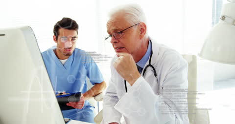 Senior Doctor and Nurse Analyzing Medical Data on Computer