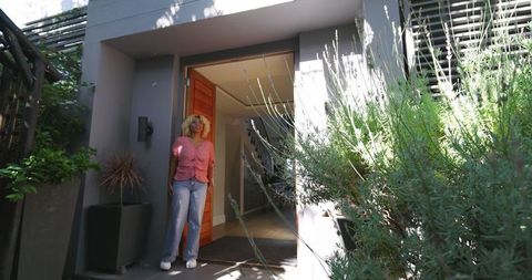 Happy Woman Enjoying Day Outside Modern Home Entrance