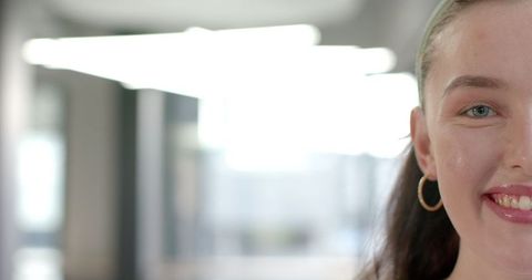 Confident Smiling Woman Close-Up in Modern Business Environment