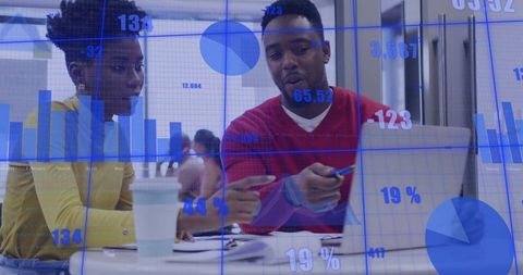 Two colleagues collaborating over laptop with data visualization overlay and business charts