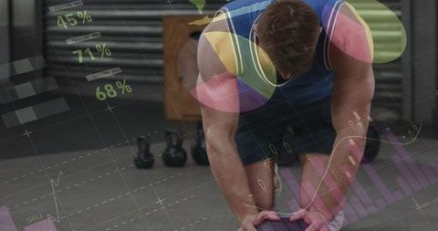 Athlete gripping medicine ball and bending during strength training with analytics overlay