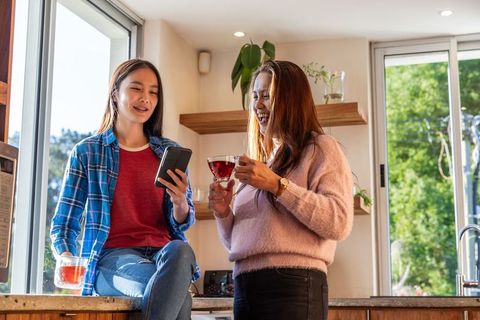 Mother and Daughter Bonding in Sunlit Kitchen with Tea