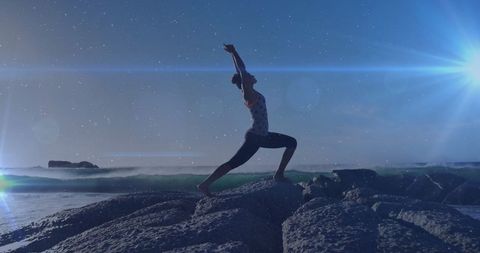 Woman Practicing Yoga Poses on Rocky Beach at Night - Download Free Stock Images Pikwizard.com