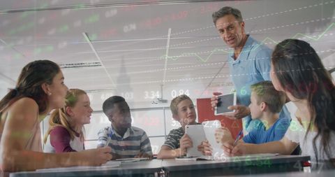 teacher using tablet to explain stock market to students - Download Free Stock Images Pikwizard.com