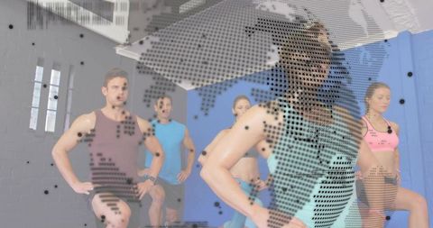 Female fitness instructor leading high-energy group workout wearing clip-on microphones