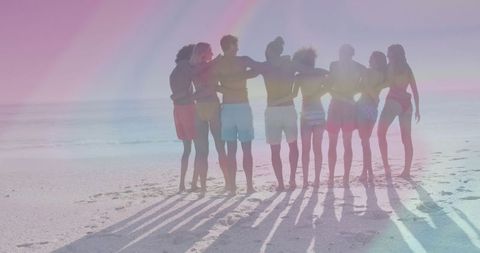 Young Friends Embracing Sunset On Beach Edge in Summer