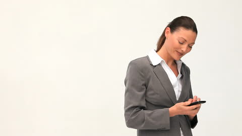 Elegant Businesswoman Texting on Smartphone in Office Attire