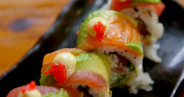 Close-up of Colorful Rainbow Sushi Roll with Avocado and Fish Topping - Download Free Stock Images Pikwizard.com