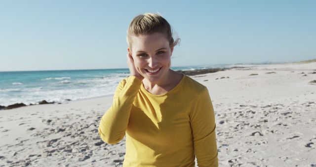 Happy Woman in Yellow Top Enjoying Beach Day by the Ocean - Download Free Stock Images Pikwizard.com