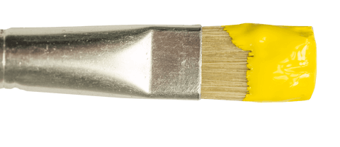 Close-up of brush with yellow paint on transparent background