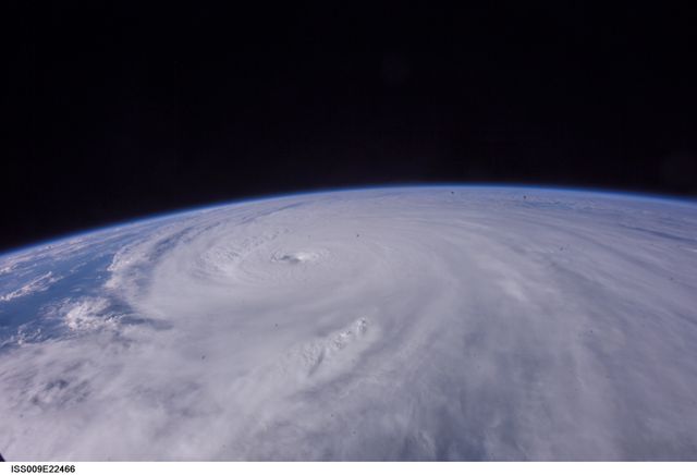 This image shows the Category 5 Hurricane Ivan in the Gulf of Mexico, photographed from the International Space Station in 2004. The image captures the immense size and force of the storm, making it valuable for educational materials on severe weather, environmental science, and space exploration. It illustrates the raw power of nature and the importance of meteorological observations. This photo can be used in scientific publications, climate change studies, and weather preparedness brochures.