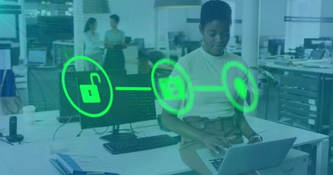 African american businesswoman using laptop with digital security interface