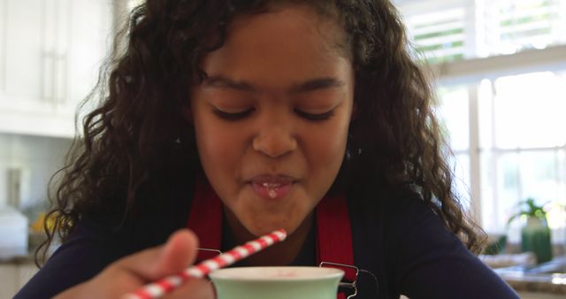 Happy Young Girl Drinking Beverage through Straw in Bright Kitchen - Download Free Stock Images Pikwizard.com