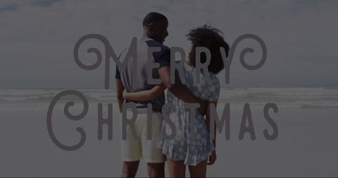 Merry Christmas Overlaid on Romantic Couple On Beach - Download Free Stock Images Pikwizard.com