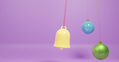 Colorful Christmas Ornaments Hanging Over Purple Background