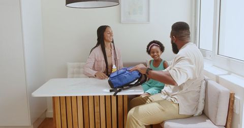 Multiracial Family Preparing for School Morning Routine in Kitchen