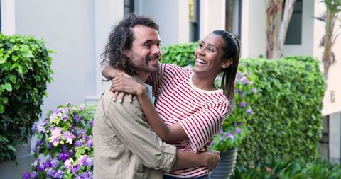 Happy couple embracing outdoors at new home