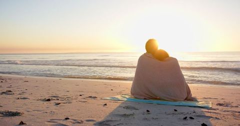 Romantic Couple Watching Sunset on Beach Embraced in Blanket - Download Free Stock Images Pikwizard.com