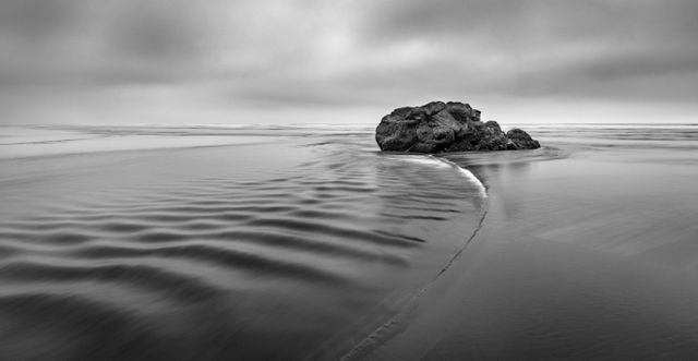 Serene Black and White Coastal Landscape with Rock Formation - Download Free Stock Photos Pikwizard.com