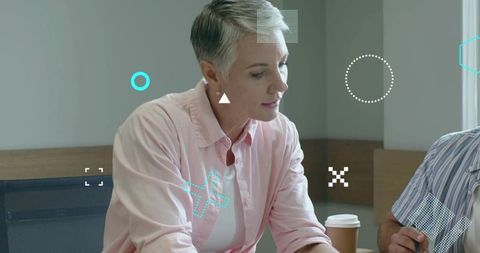 Mature Professional Woman Analyzing Documents in Modern Workspace