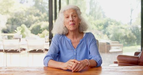 Elderly Woman Communicating Over Video Call At Home