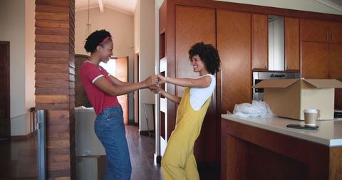 Couple Embracing and Unpacking in New Home Kitchen