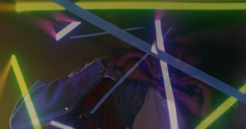 Male singer reacting to light cue, singing into microphone, syncing neon leds, moody club
