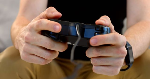 Shows person focusing on a video game, ideal for themes related to gaming, technology, or recreation. Picture can be used for blogs, gaming websites, or technology-focused marketing.