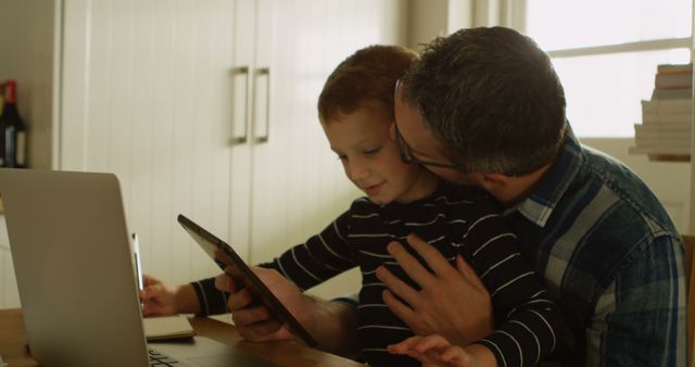 Close-Up of Father Balancing Remote Work and Childcare - Download Free Stock Images Pikwizard.com